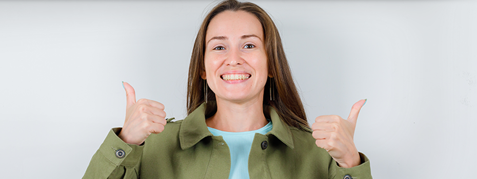 woman smiling with thumbs up